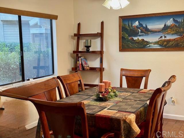 dining room with hardwood / wood-style flooring and a healthy amount of sunlight