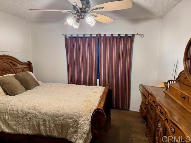 carpeted bedroom with ceiling fan and a textured ceiling