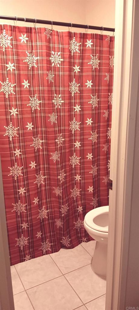 bathroom with tile patterned flooring and toilet