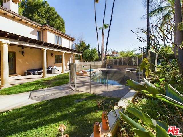 view of pool with a yard and a patio area