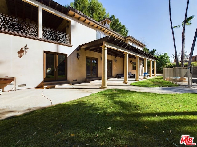 back of house featuring a yard and a patio area