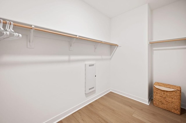 walk in closet with wood-type flooring