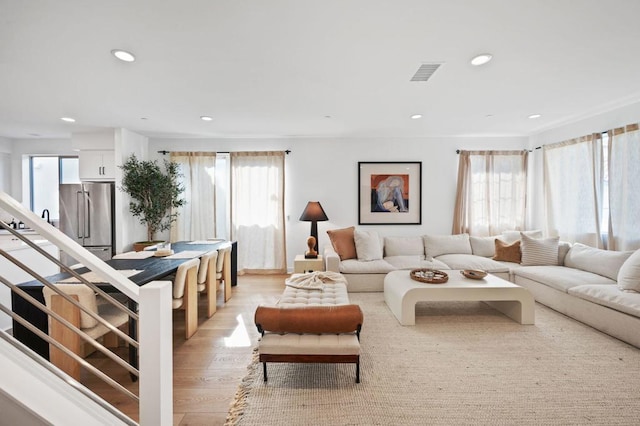 living room featuring plenty of natural light and light hardwood / wood-style floors