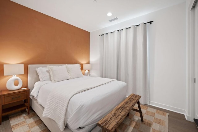 bedroom with dark wood-type flooring