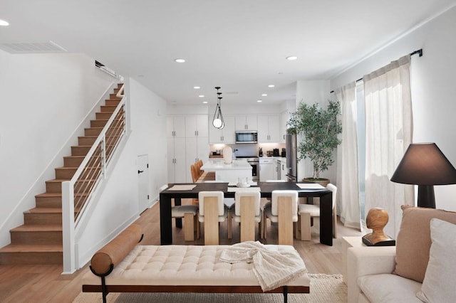 dining space with light hardwood / wood-style floors