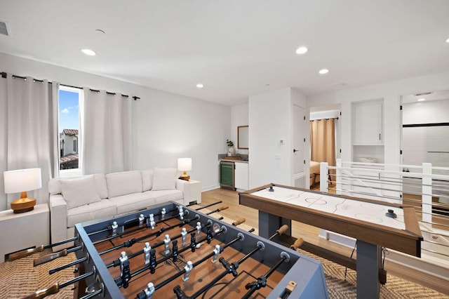 playroom with wood-type flooring and beverage cooler