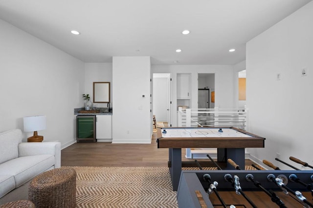 recreation room featuring wine cooler and wood-type flooring