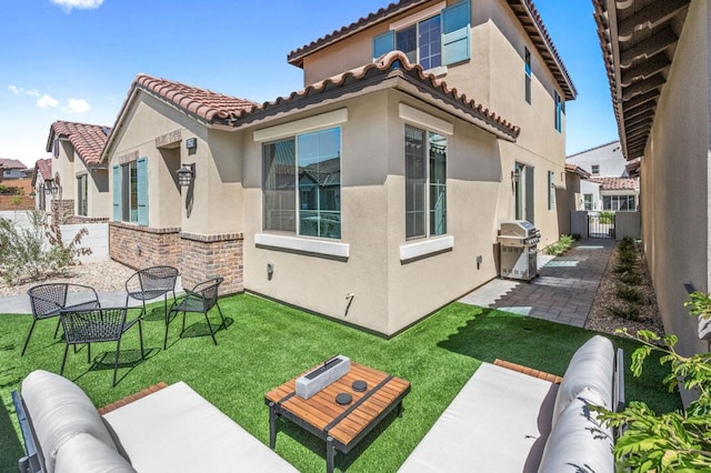 back of property with an outdoor hangout area, a lawn, and a patio area