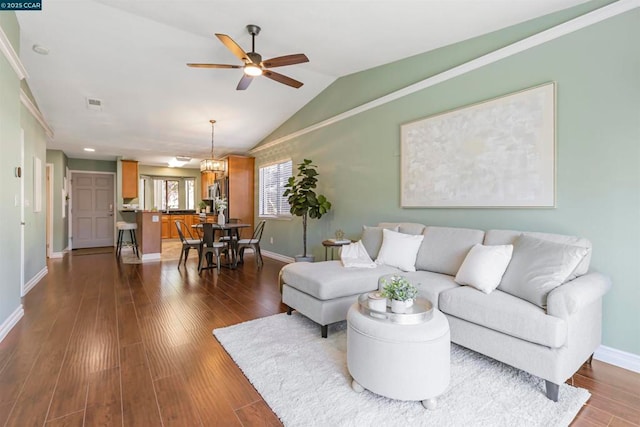 living room with lofted ceiling, dark hardwood / wood-style floors, and ceiling fan