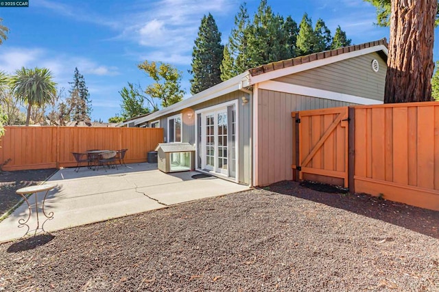 rear view of property featuring a patio and french doors