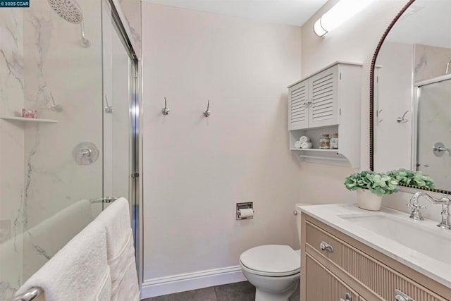 bathroom featuring tile patterned floors, vanity, toilet, and an enclosed shower