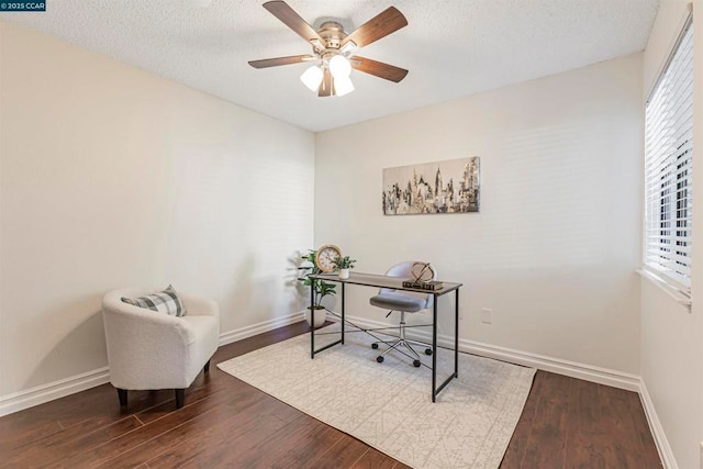 office area featuring ceiling fan, a textured ceiling, wood-type flooring, and a healthy amount of sunlight