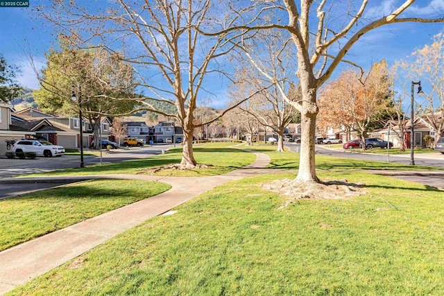 view of property's community featuring a lawn