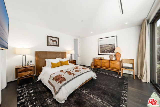 bedroom featuring dark hardwood / wood-style flooring