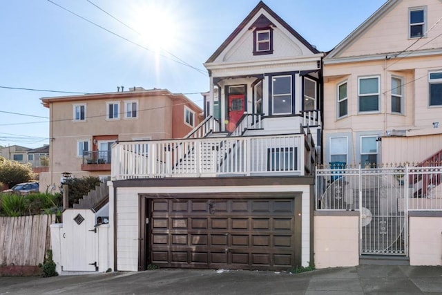 view of front of property featuring a balcony and a garage