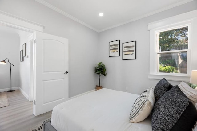 bedroom featuring wood-type flooring and crown molding