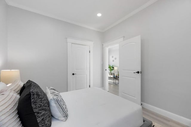 bedroom with light hardwood / wood-style flooring and ornamental molding