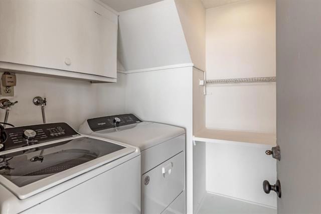 laundry area with cabinets and washing machine and clothes dryer