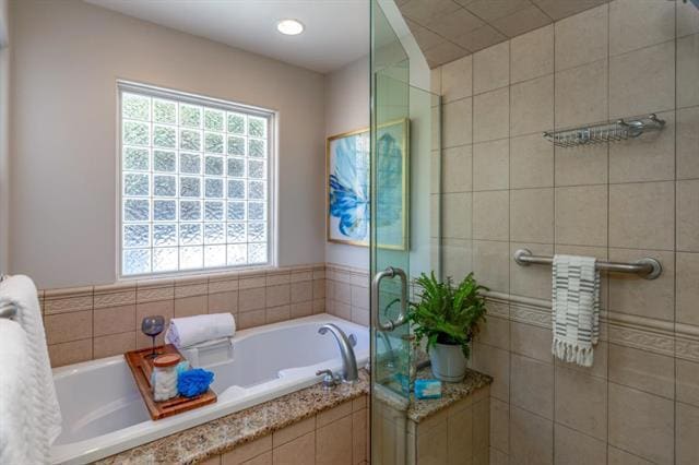 bathroom featuring a relaxing tiled tub