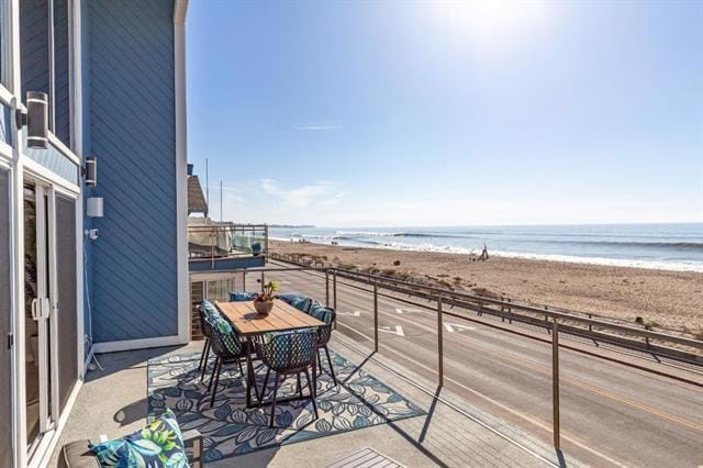 balcony with a beach view and a water view