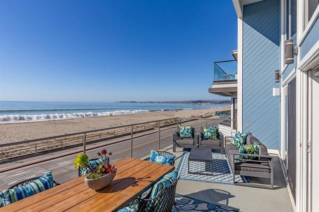 balcony featuring a view of the beach, a water view, and an outdoor living space