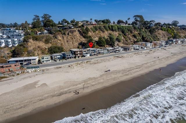 birds eye view of property with a beach view and a water view