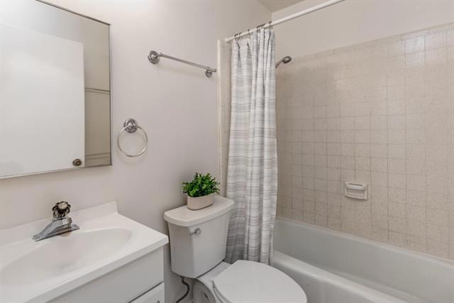 full bathroom featuring vanity, toilet, and shower / bathtub combination with curtain