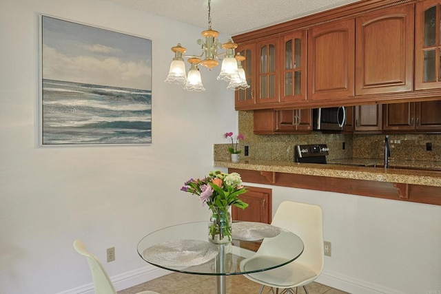 dining room with sink and an inviting chandelier