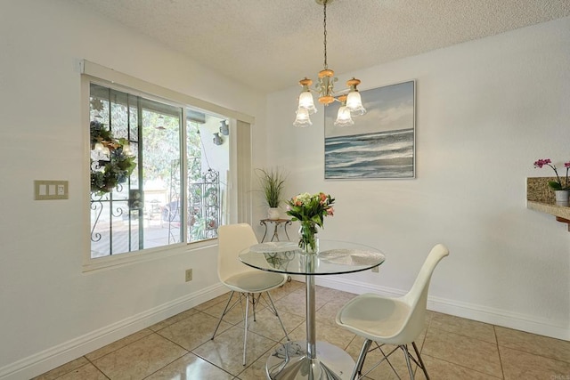 dining area with light tile patterned flooring, a notable chandelier, and a textured ceiling