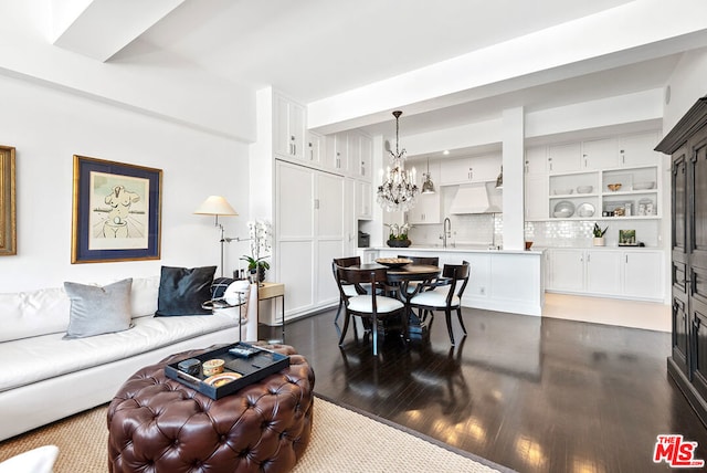 living room featuring a chandelier and sink