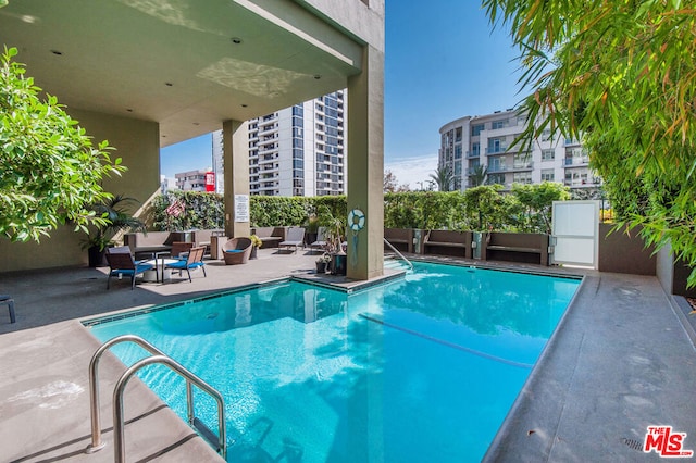 view of pool featuring a patio