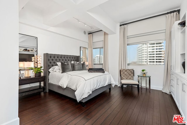 bedroom featuring dark wood-type flooring and track lighting