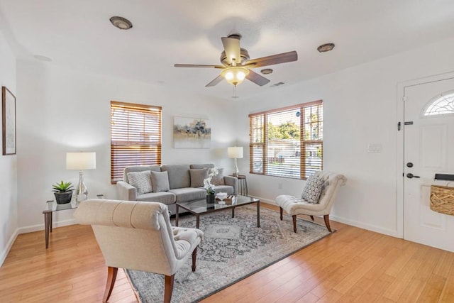 living room featuring ceiling fan and light hardwood / wood-style floors