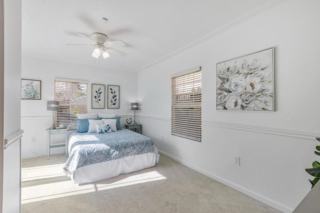 bedroom with ceiling fan and light colored carpet