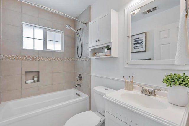 full bathroom with vanity, toilet, and tiled shower / bath