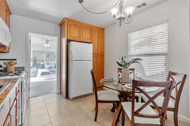 tiled dining area with a notable chandelier