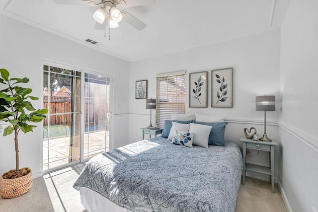 carpeted bedroom featuring crown molding, access to outside, and ceiling fan