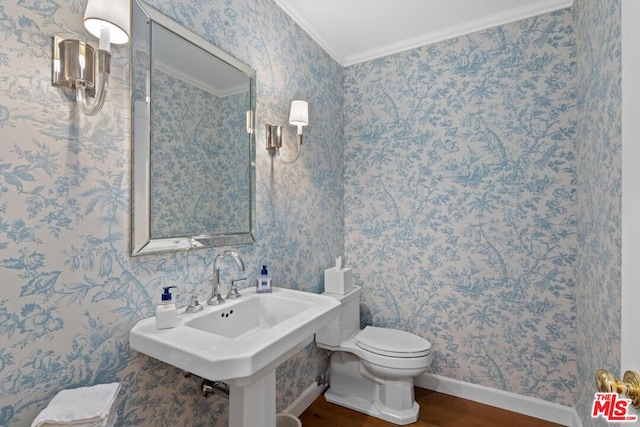 bathroom with crown molding, sink, hardwood / wood-style floors, and toilet