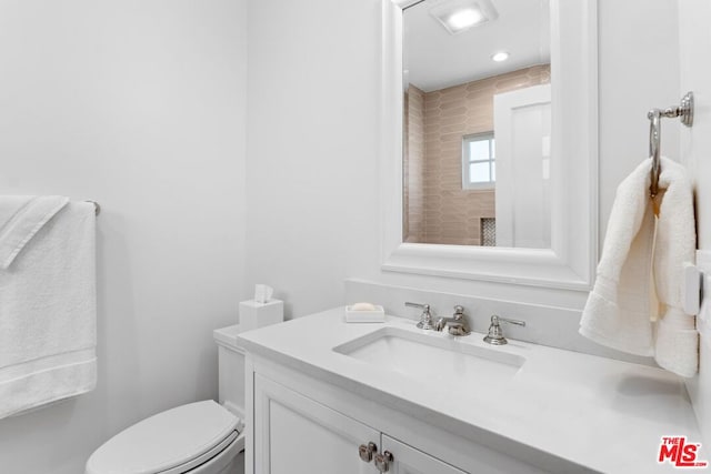 bathroom featuring vanity and toilet