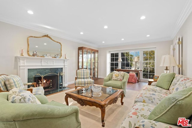 living room with crown molding, a high end fireplace, and light hardwood / wood-style floors