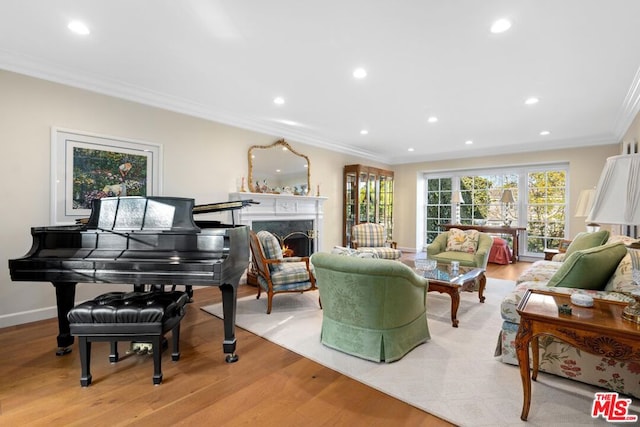 living room featuring ornamental molding, light hardwood / wood-style floors, and a premium fireplace