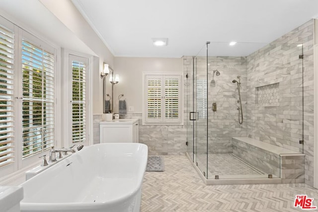 bathroom with crown molding, vanity, and plus walk in shower