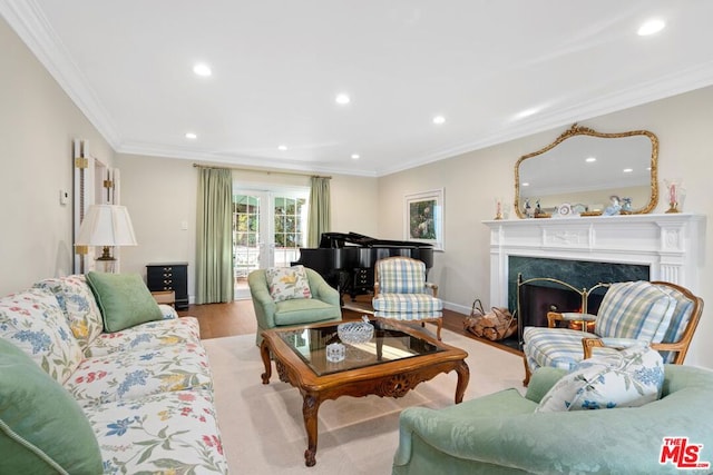 living room with crown molding, a high end fireplace, light hardwood / wood-style flooring, and french doors