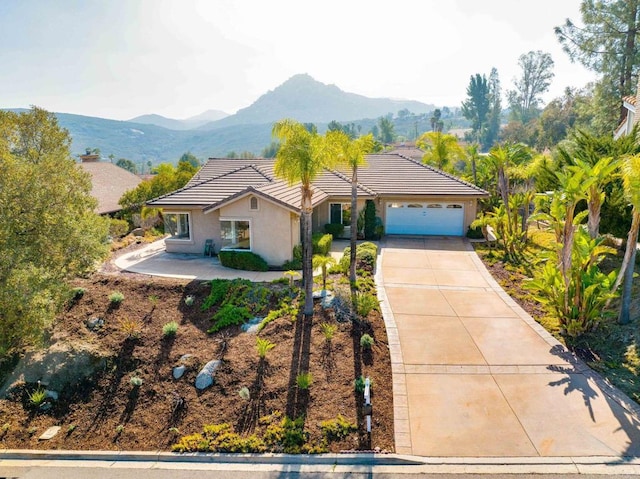 view of front of home featuring a garage and a mountain view