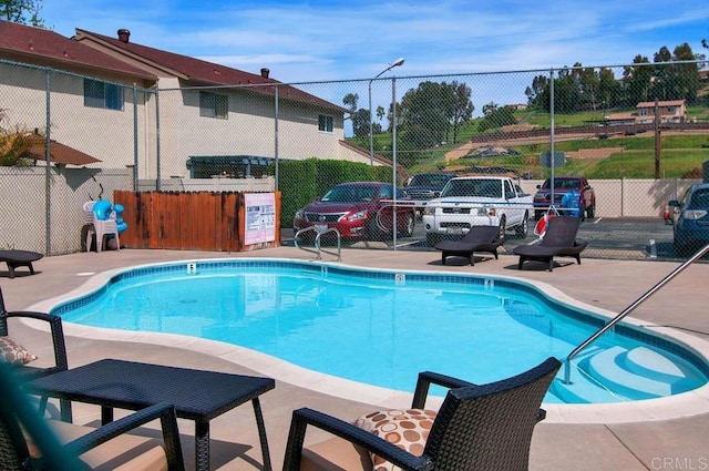 pool featuring a patio area and fence