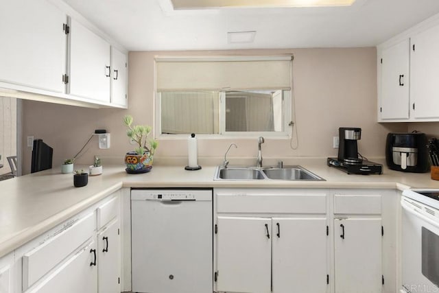 kitchen featuring light countertops, white appliances, white cabinets, and a sink