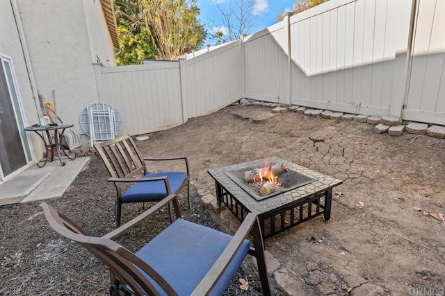 view of patio / terrace with an outdoor fire pit and a fenced backyard