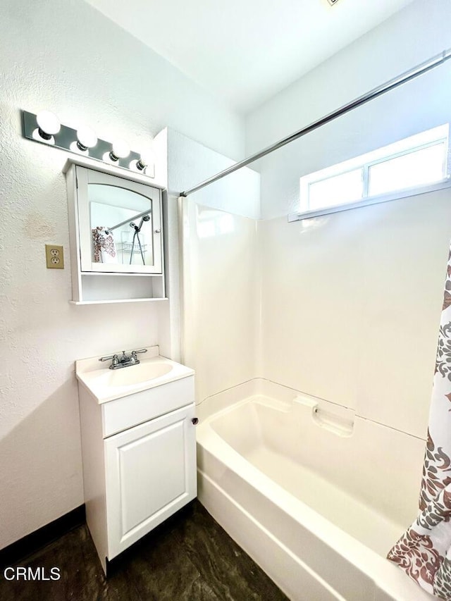 bathroom with shower / tub combo and vanity