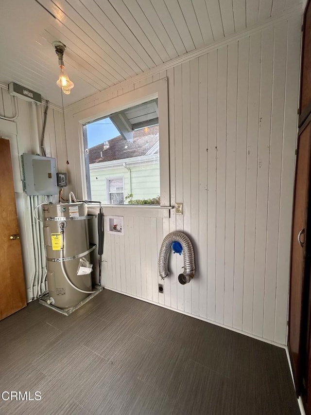 washroom featuring strapped water heater, hookup for a washing machine, laundry area, wooden ceiling, and electric panel