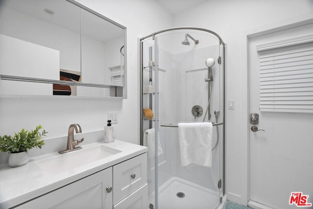 bathroom with a shower with door and vanity